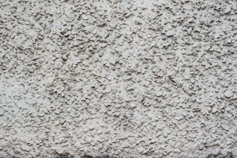 The texture of the street wall is gray with large irregularities on it Stock Photos