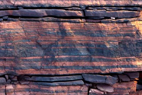 The texture of the striped stone at sunset. Abstract natural macro pattern. Stock Photos