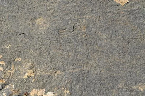 The texture of the surface of gray stone with cracks and light spots of layer Foto stock