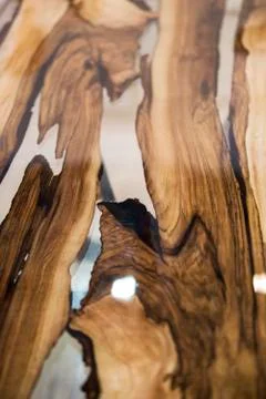 Texture of the table is made from solid wood treated with varnish and epoxy r Stock Photos