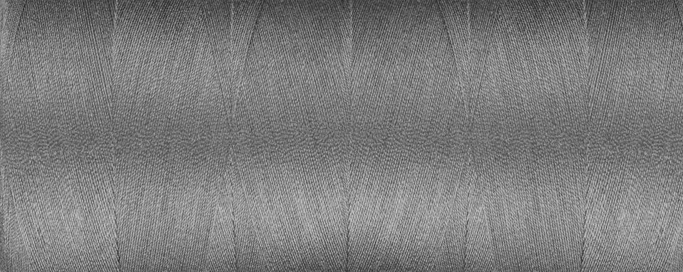 Texture of thread for a sewing machine gray colors on a white background Foto stock