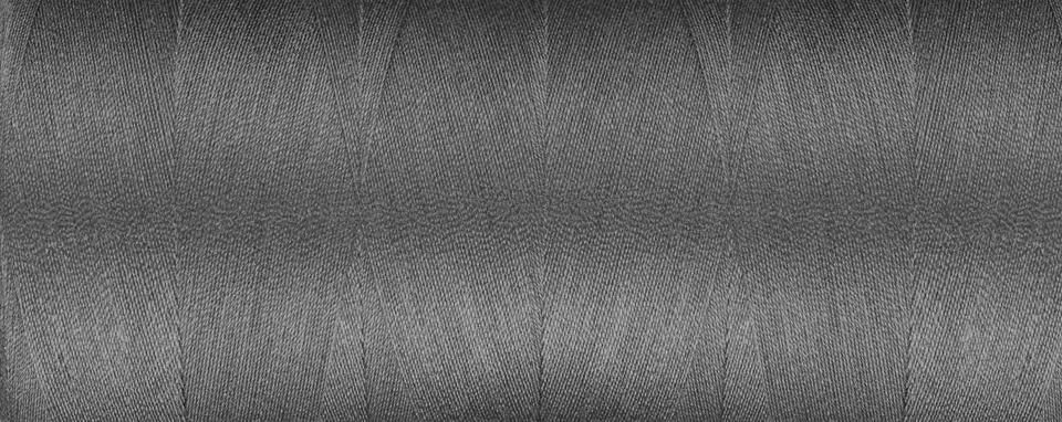 Texture of thread for a sewing machine gray colors on a white background Foto stock