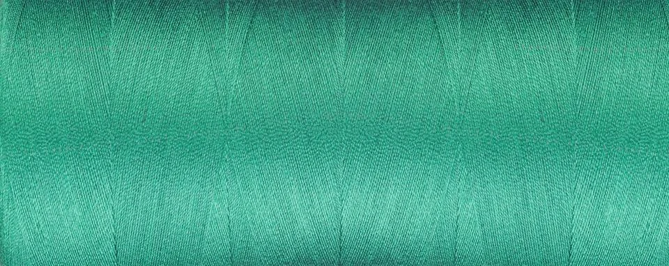 Texture of thread for a sewing machine green color on a white background Stock-Fotos