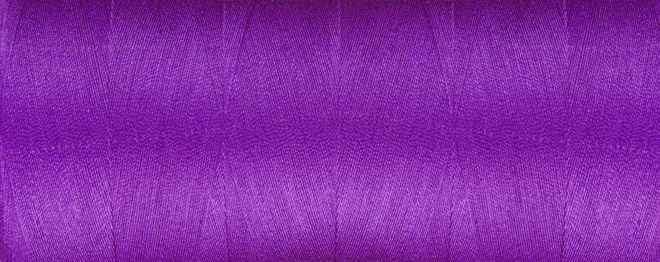 Texture of thread for a sewing machine purple colors on a white background Foto stock