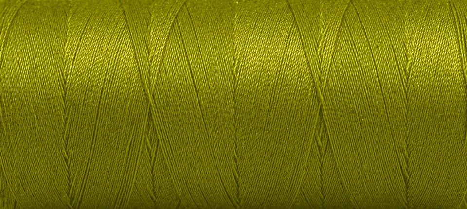Texture of threads in a spool of green color on a white background Stock Photos