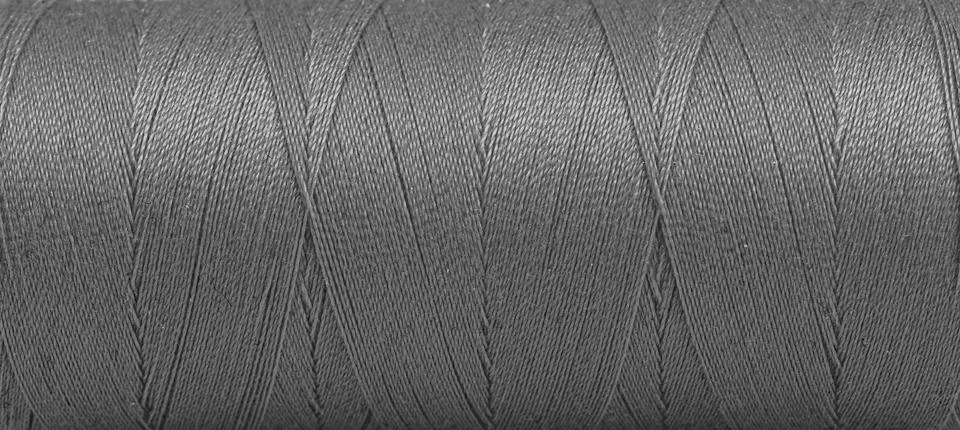 Texture of threads in a spool of grey color on a white background Stock Photos