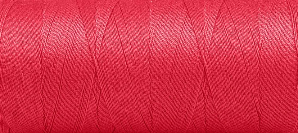 Texture of threads in a spool of red color on a white background Stock Photos