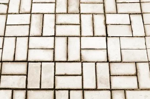 The texture of the tiles of the sidewalk grey stackable blocks. Stock Photos