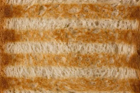 The texture of toasted bread baked on the grill with characteristic stripes. Stock Photos