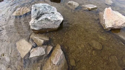 Texture of tranquil waves of river at autumn time against the background of ston Video stock 106549966