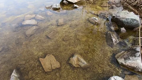 Texture of tranquil waves of river at autumn time against the background of ston Video stock 106549981