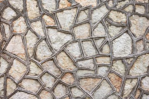 The texture of the triangular tiles bonded with cement on the wall. Stock Photos
