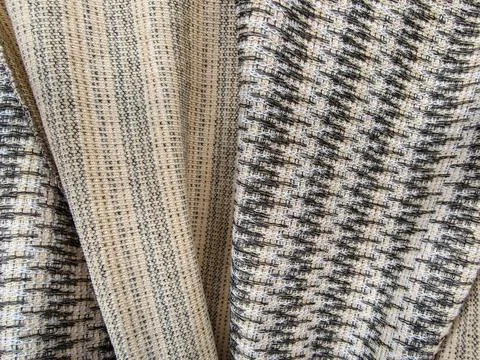 Texture of Two Sided Knit Fabric Material with Beige and Black Pattern Folds Stock-Fotos