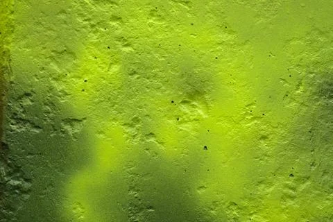 The texture of the unevenly painted wall is light green. The wall with irregu Stock Photos