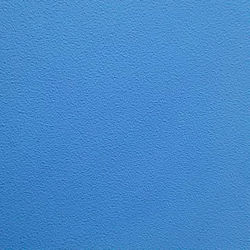 Texture of an unevenly painted wall with rough edges, blue background close-u Stock Photos