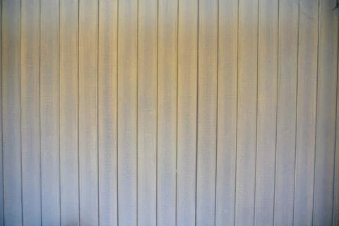 Texture of a vertical corrugated metal wall surface with a weathered brownish Stock Photos