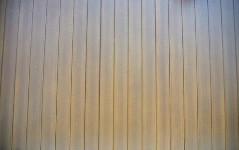 Texture of a vertical corrugated metal wall surface with a weathered brownish Stock Photos