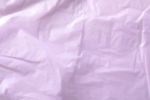 Texture of violet plastic bag as background, closeup Photos