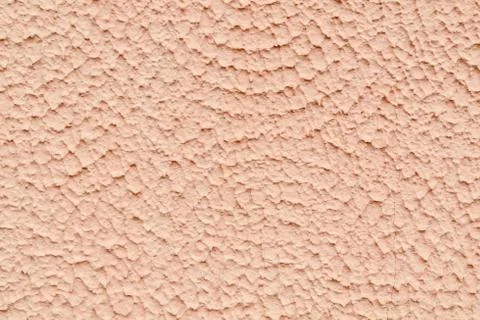 The texture of the wall covered with plaster and painted beige paint Stock Photos