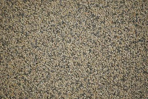  Texture of a wall covered with tiny colored and black pebbles that create... Stock Photos