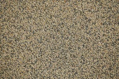  Texture of a wall covered with tiny colored and black pebbles that create... Stock Photos