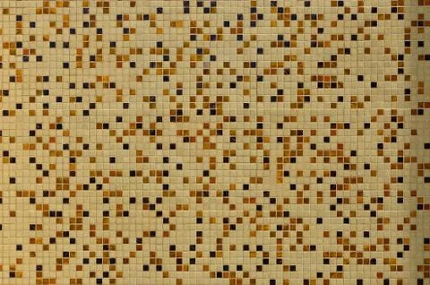 The texture of the wall, decorated with a mosaic of various small square tile Foto stock