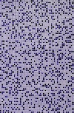 The texture of the wall, decorated with a mosaic of various small square tile Foto stock