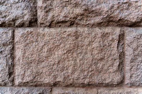 Texture. The wall is made of rectangular blocks of red granite. 스톡 사진