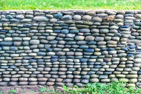 Texture. The wall is made of small pebble stone Stock Photos