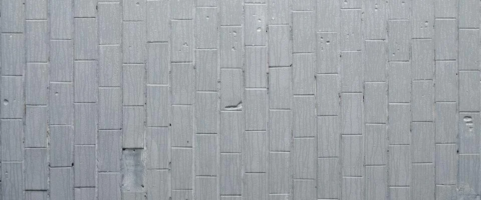 The texture of the wall from the old tile, painted gray under the influence o Stock Photos