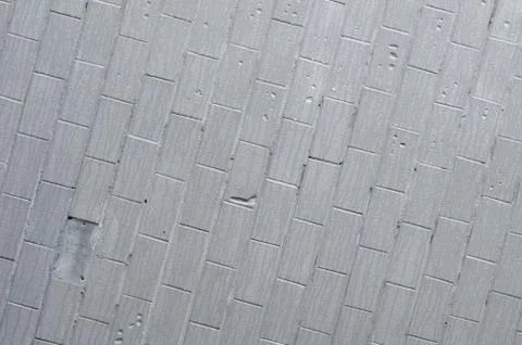 The texture of the wall from the old tile, painted gray under the influence o Stock Photos