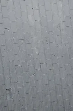The texture of the wall from the old tile, painted gray under the influence o Stock Photos