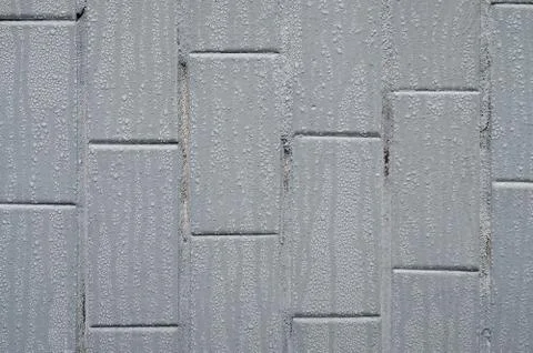 The texture of the wall from the old tile, painted gray under the influence o Stock Photos