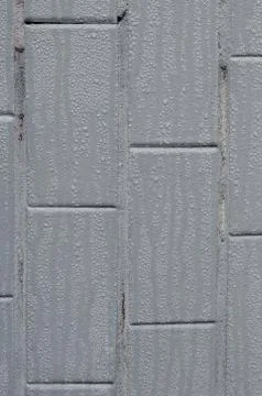 The texture of the wall from the old tile, painted gray under the influence o Stock Photos