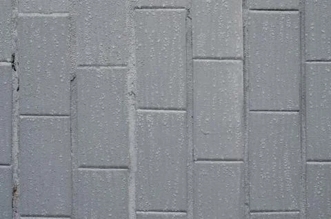 The texture of the wall from the old tile, painted gray under the influence o Stock Photos
