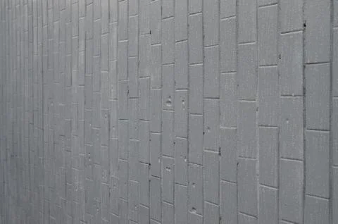 The texture of the wall from the old tile, painted gray under the influence o Stock Photos