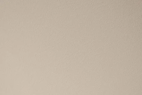 The texture of the wall painted with beige paint. Stock Photos