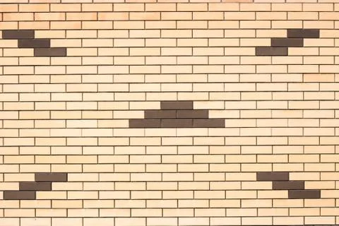 Texture of a wall of yellow brick with a pattern Stock Photos