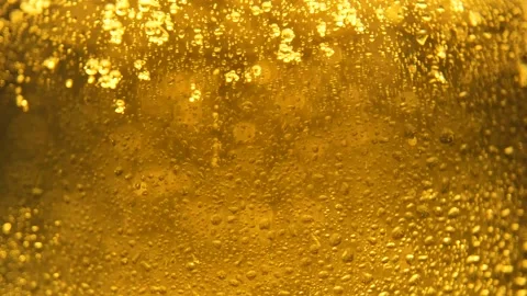 Texture water drops on the orange yellow glass - background. Cold Light Beer in Stock Footage 146323986