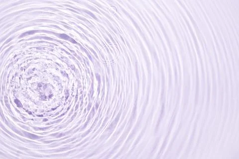 The texture of water on a lilac background. Stock Photos