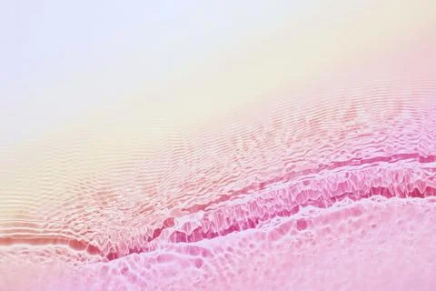 The texture of water on a pink background. Stock Photos