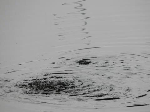 Texture of water in a river, surface in the rain, stains Stock Photos