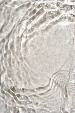 The texture of water on a sand background. Stock Photos
