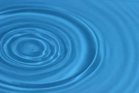 Texture with waves and drops of blue water Stock Photos