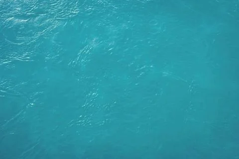 The texture of the waves of blue color of fast-flowing water in the river. Stock Photos