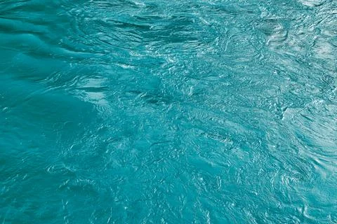 The texture of the waves of blue color of fast-flowing water in the river. Stock Photos