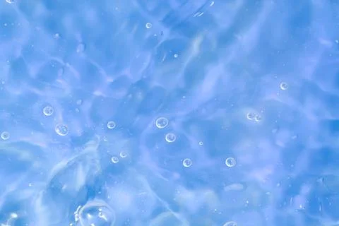 Texture of waves of bubbling water on a pink background Stock Photos