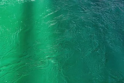The texture of the waves of turquoise color of fast-flowing water in the rive Stock Photos