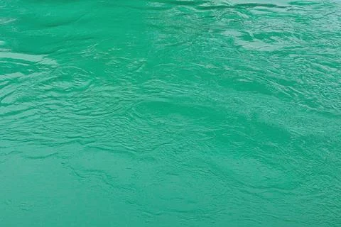 The texture of the waves of turquoise color of fast-flowing water in the rive Stock Photos