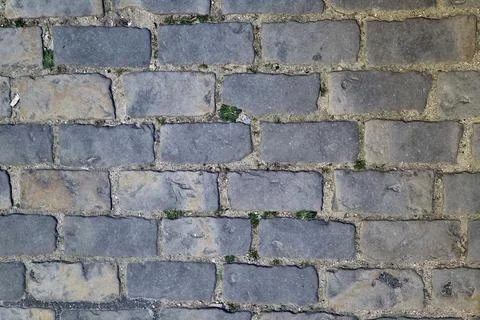 Texture of Weathered Brick Wall with Subtle Green Moss Details for Background Stock Photos